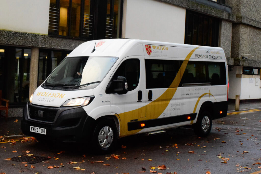 Wolfson's electric minibus parked outside of the College.